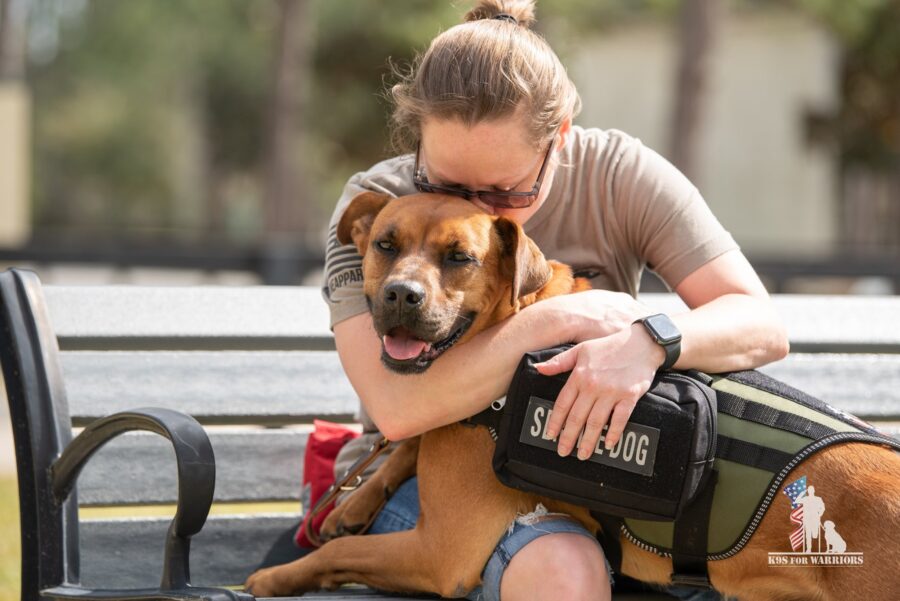 Photo of a person hugging a service dog