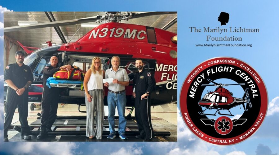 An image of 5 people standing by a helicopter, logo and text that says 'INTEGRITY COMPASSION, EXCELLENCE, MERCY FLIGHT CENTRAL FINGER VALLEY LAKES CENTRAL CENTRALNY NY MOHAWK VALLEY’ ‘The Marilyn Lichtman Foundation www.MarilynLichtmanFoundatin.org'