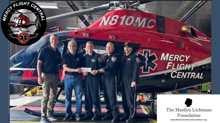 Image of several people and a helicopter. Logo and text The Marilyn Lichtman Foundation www.MarilynichtmanFoundation.org ; Mercy Flight Central
