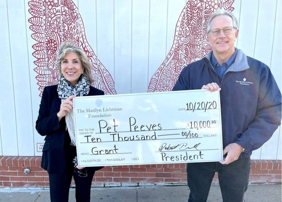 Two people holding an oversized check.