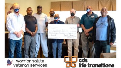 8 people and oversized check, and logos for Warrior Salute Veteran services and CDS life Transitions