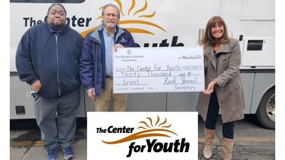 image of three people with oversized check and logo for The Center for Youth