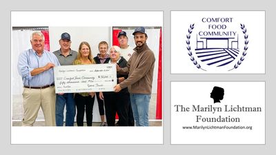 Photo of 7 people holding oversized check, logos of Comfort Food Community and Lichtman Foundation.