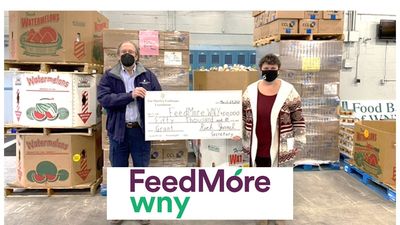 image of two people holding oversized check and logo for FeedMore WNY