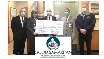 Five people and oversized check and logo for Good Samaritan Hospital Foundation