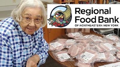 Person seated at table and bags of food. Logo of Regional Food Bank