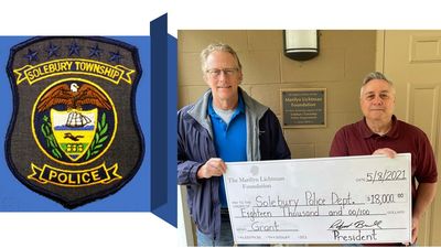 image of two people holding oversized check and logo for Solebury Township Police