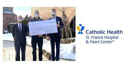 Three people holding oversized check and logo for Catholic Health St. Francis Hospital
